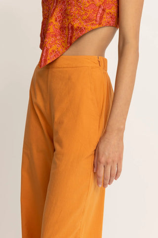 Orange wide leg pants with high tailored waistband and relaxed fit.