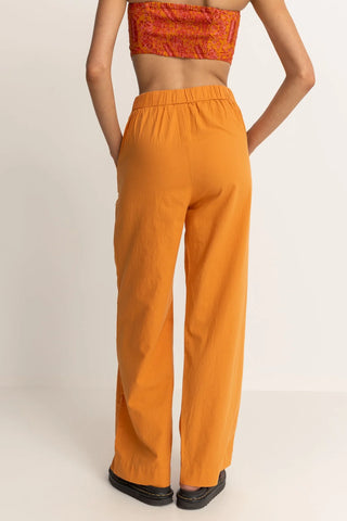 Orange wide leg pants with high tailored waistband and relaxed fit.