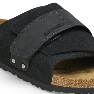 Black Birkenstock Kyoto sandals with nubuck/suede upper, adjustable hook and loop closure, and comfortable footbed.