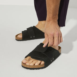 Black Birkenstock Kyoto sandals with nubuck/suede upper, adjustable hook and loop closure, and comfortable footbed.