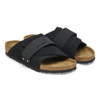 Black Birkenstock Kyoto sandals with nubuck/suede upper, adjustable hook and loop closure, and comfortable footbed.