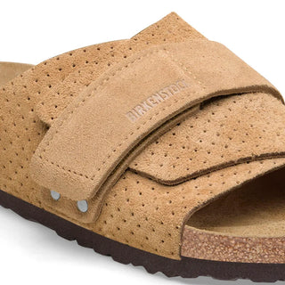 Beige Birkenstock Kyoto slides with embossed suede and adjustable hook-and-loop straps.