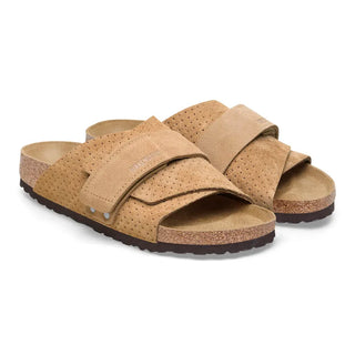 Beige Birkenstock Kyoto slides with embossed suede and adjustable hook-and-loop straps.