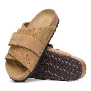 Beige Birkenstock Kyoto slides with embossed suede and adjustable hook-and-loop straps.