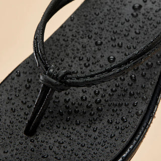 Black Olukai 'Aka Women's Beach Sandals with bikini-inspired straps.