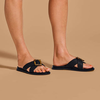 Olukai La'i Slide Women's Sandals in Black with tortoise shell buckle.