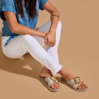 Olukai La'i Slide Women's Sandals in Taupe with tortoise shell buckle.