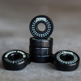 Bronson Speed Co X Creature Skateboards G3 bearings with spider web graphic and glow-in-the-dark coffin box.