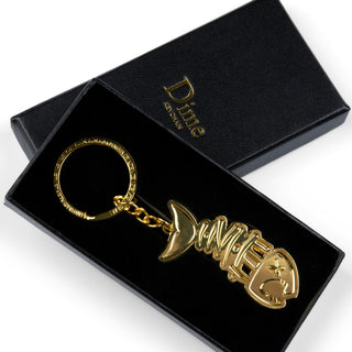 Dime Bones Keychain in Gold with skeleton design, made from zinc alloy.