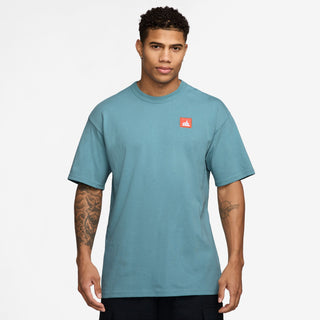 Nike SB Skate T-Shirt in Denim Turquoise, midweight cotton with a ribbed collar for comfort and easy layering.