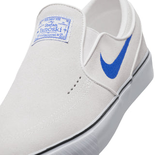 Nike SB Janoski+ Slip Shoes in Summit White and Hyper Royal, featuring suede upper and Zoom Air cushioning.