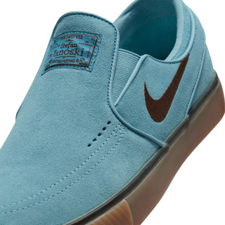 Nike SB Janoski Slip Shoes in Denim Turquoise/Cacao Wow with suede upper and Zoom Air cushioning for responsive performance.