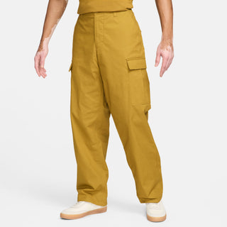 Nike SB Kearny cargo skate pants in Bronzine, durable ripstop fabric, six pockets, drawcord waist.