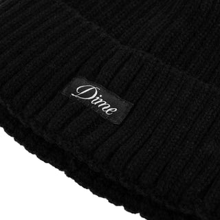 Black fold beanie with sleek design, crafted from acrylic.