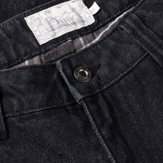 Black washed denim pant with flannel lining, wavy pockets, and distressing.