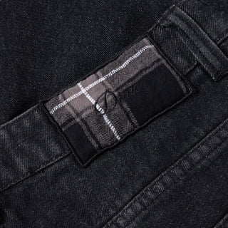 Black washed denim pant with flannel lining, wavy pockets, and distressing.