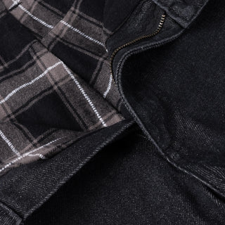 Black washed denim pant with flannel lining, wavy pockets, and distressing.