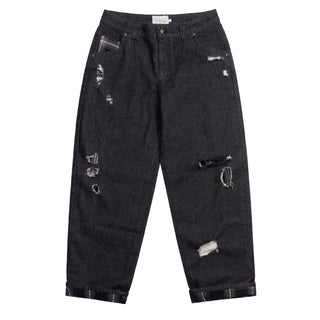 Black washed denim pant with flannel lining, wavy pockets, and distressing.