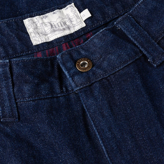 Indigo denim pants with flannel lining, distressing, and wavy pockets.