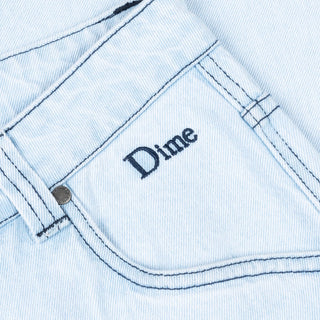 Faded blue relaxed denim pants with logo embroidery and wave patch pockets.