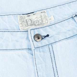 Faded blue relaxed denim pants with logo embroidery and wave patch pockets.