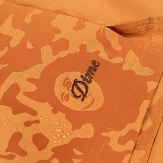 Dime MTL Secret Swim Shorts in Orange with water-reactive print and cursive logo embroidery.