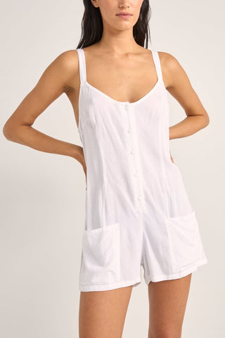 Rhythm Jayda Playsuit in white with adjustable straps, button detailing, and side pockets.