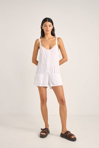 Rhythm Jayda Playsuit in white with adjustable straps, button detailing, and side pockets.