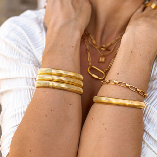 Gold Earthbound Bangle with 18K plating, root-inspired design, hypoallergenic, and water-resistant.