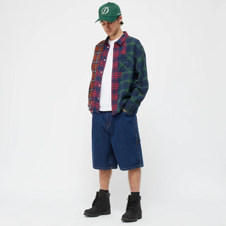 Multi-colored plaid shirt with wavy seams and embroidered chest pocket.