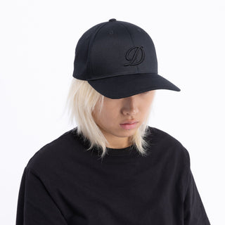 The Dime D Full Fit Cap in Black, made from 100% cotton, features a structured snapback closure and bold "D" logo. Available now at Drift House.