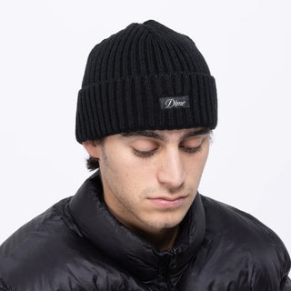 Black fold beanie with sleek design, crafted from acrylic.