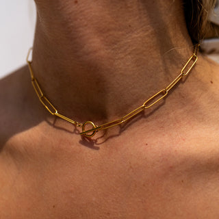 Gold necklace with 18K plating, toggle clasp, hypoallergenic stainless steel, and water-resistant design.