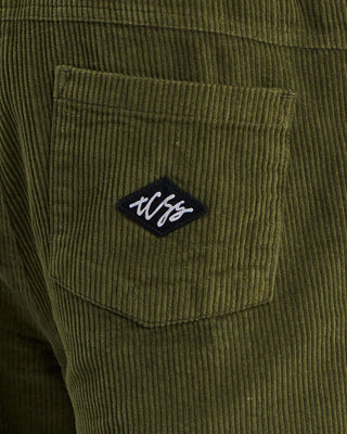 Critical Slide Society Fever Pant in Olive, straight-leg fit with elastic waist, drawcord, and 8 wale cotton corduroy.