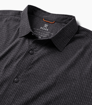 Roark Bless Up Shirt in black, lightweight perforated design, soft rubberized buttons, moisture-wicking Tactel™ fibers, short sleeve fit.