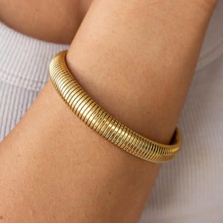 Gold Earthbound Bangle with 18K plating, root-inspired design, hypoallergenic, and water-resistant.