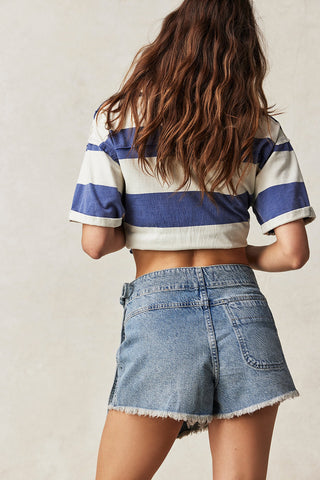 Free People Emmy Denim Skort with side-tie wrap, asymmetrical design, and raw-edge hemline.