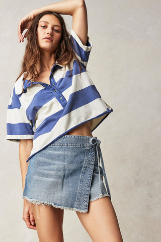 Free People Emmy Denim Skort with side-tie wrap, asymmetrical design, and raw-edge hemline.