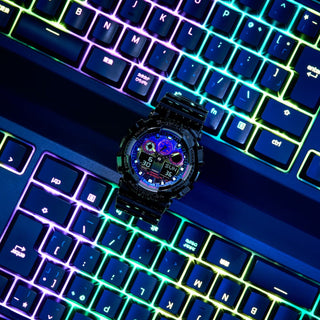 G-SHOCK GA100RGB-1A watch with glossy black bezel, multicolored face, and LED light.